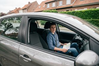 Jeune homme confiant dans une voiture urbaine moderne